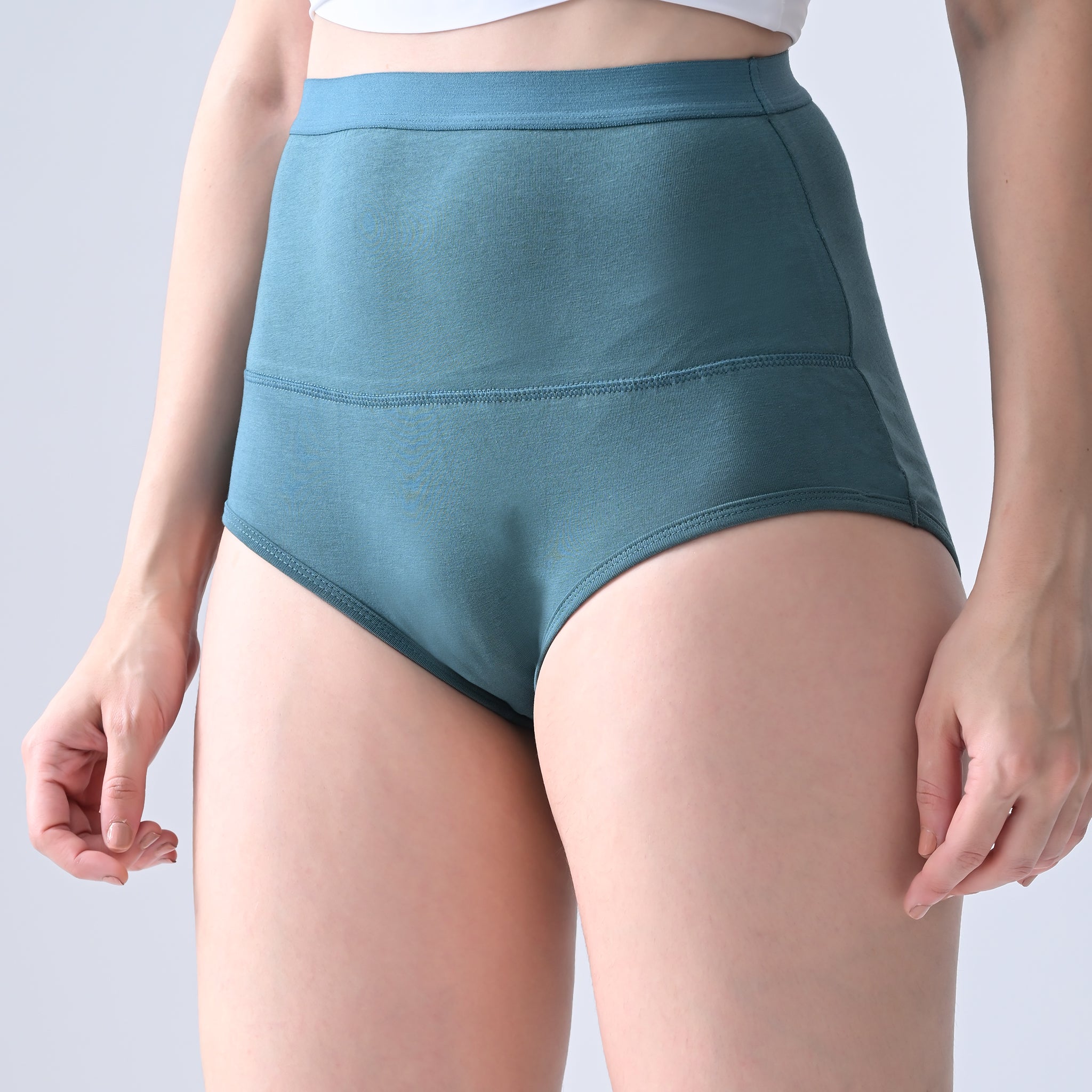 Woomly's leakproof Teal high-waisted underwear on a plain background