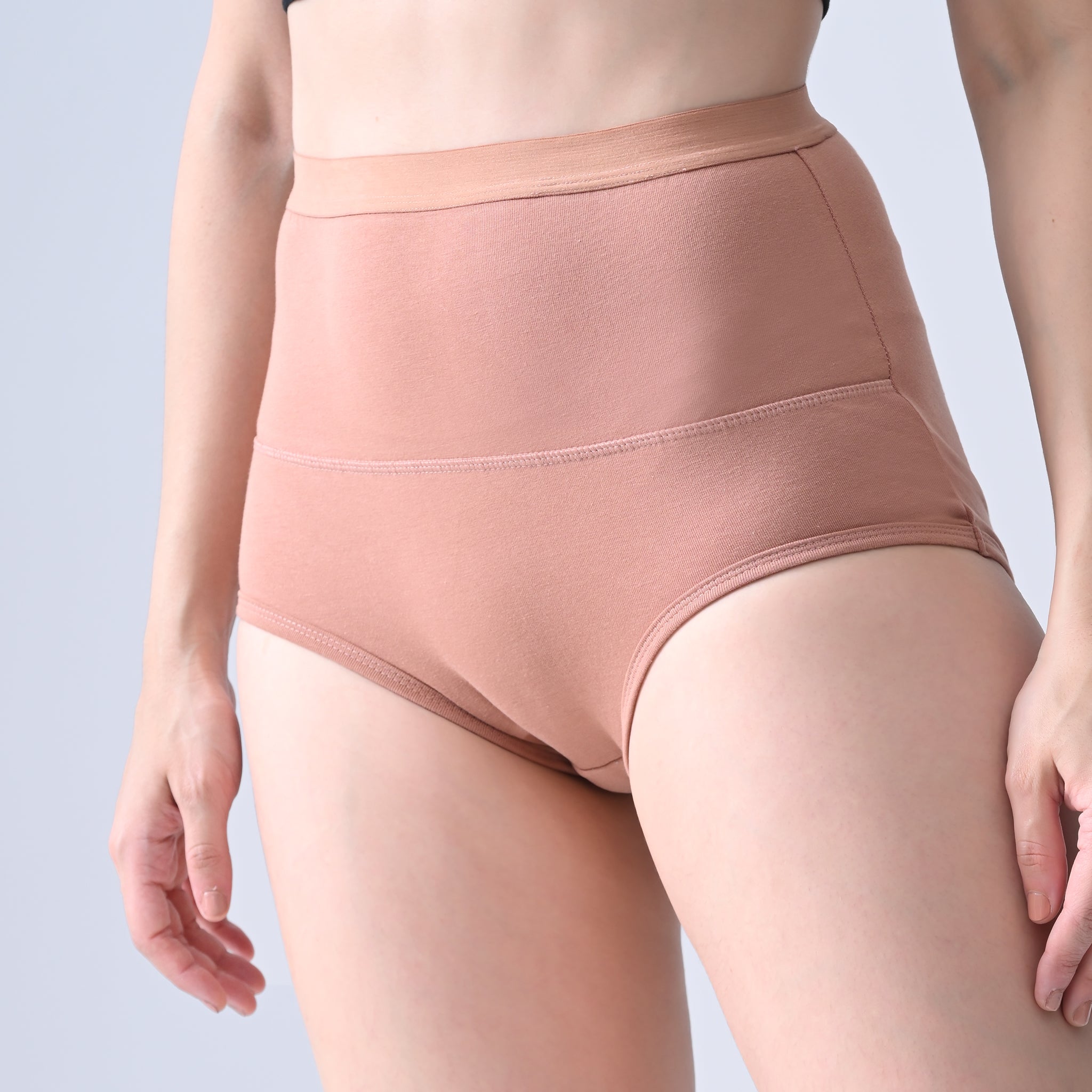 Woomly's leakproof and Urine leak Nude color high-waisted underwear on a plain background